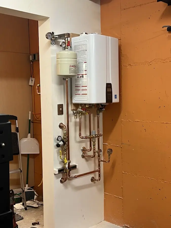Plumbing technician inspecting water heater connections in Mount Arlington